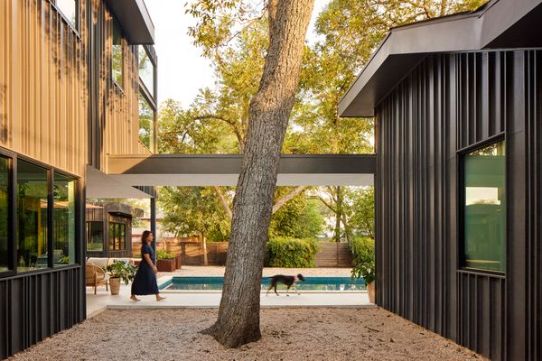 A covered walkway connects the main house (at left) with a flexible-use ADU. The smaller structure was initially offered to Bhavani's parents, but they opted to live under the same roof as the rest of the family. 