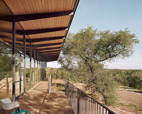 Deep overhangs on either side protect the house from direct sunlight, especially on hot days. Miguel used Douglas Fir decking for the ceiling—a durable material that brings warmth to the stark steel beams.