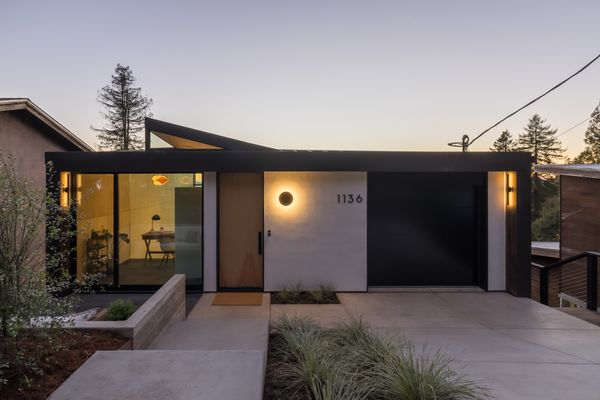 A unique creased roofline peels upward to capture light through a triangulated clerestory window, bathing the interiors with natural light.