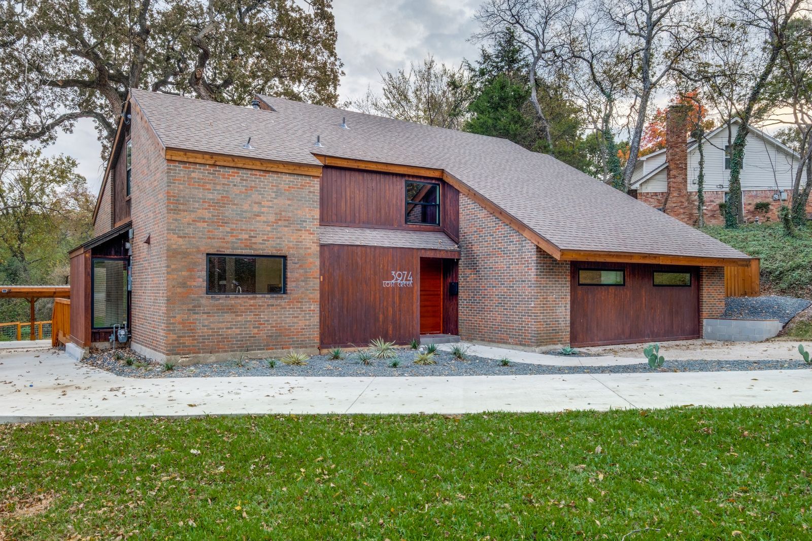 The updated ’70s residence has a a dramatic sloped roof, a double-height living area, and a big backyard.