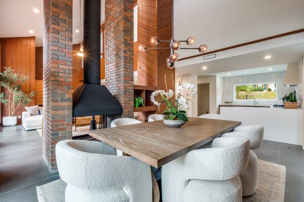 The fireplace divides the living and dining areas, open on both sides.