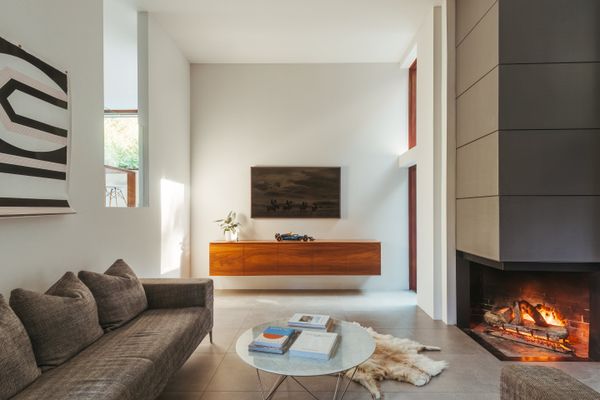 A zinc-covered gas fireplace helps to warm the living room.