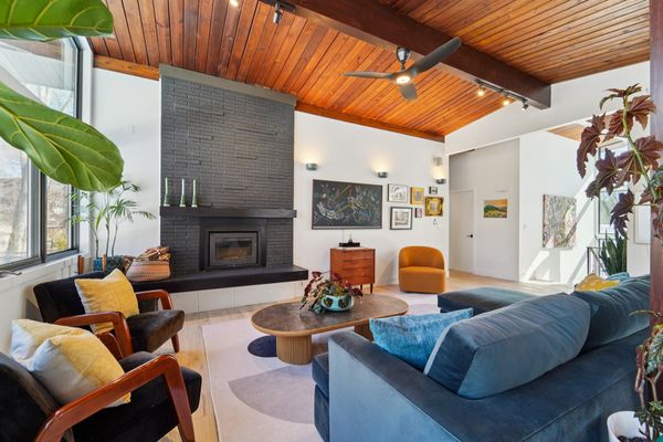 A wood-burning fireplace warms the living room.