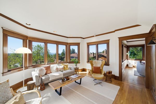 Original Morgan details including multi-pane wood windows, built-in elements, and a living room fireplace remain beautifully intact. Every detail feels intentional.