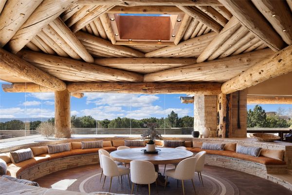 The ceiling above the dining area features a unique structure with an opening in the middle, dubbed 
