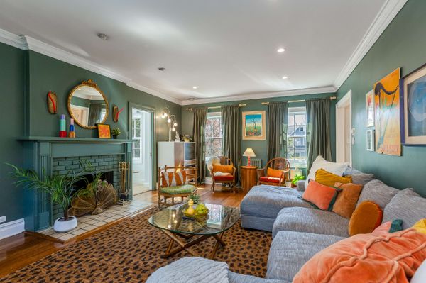 A wood-burning fireplace helps to anchor the living room.