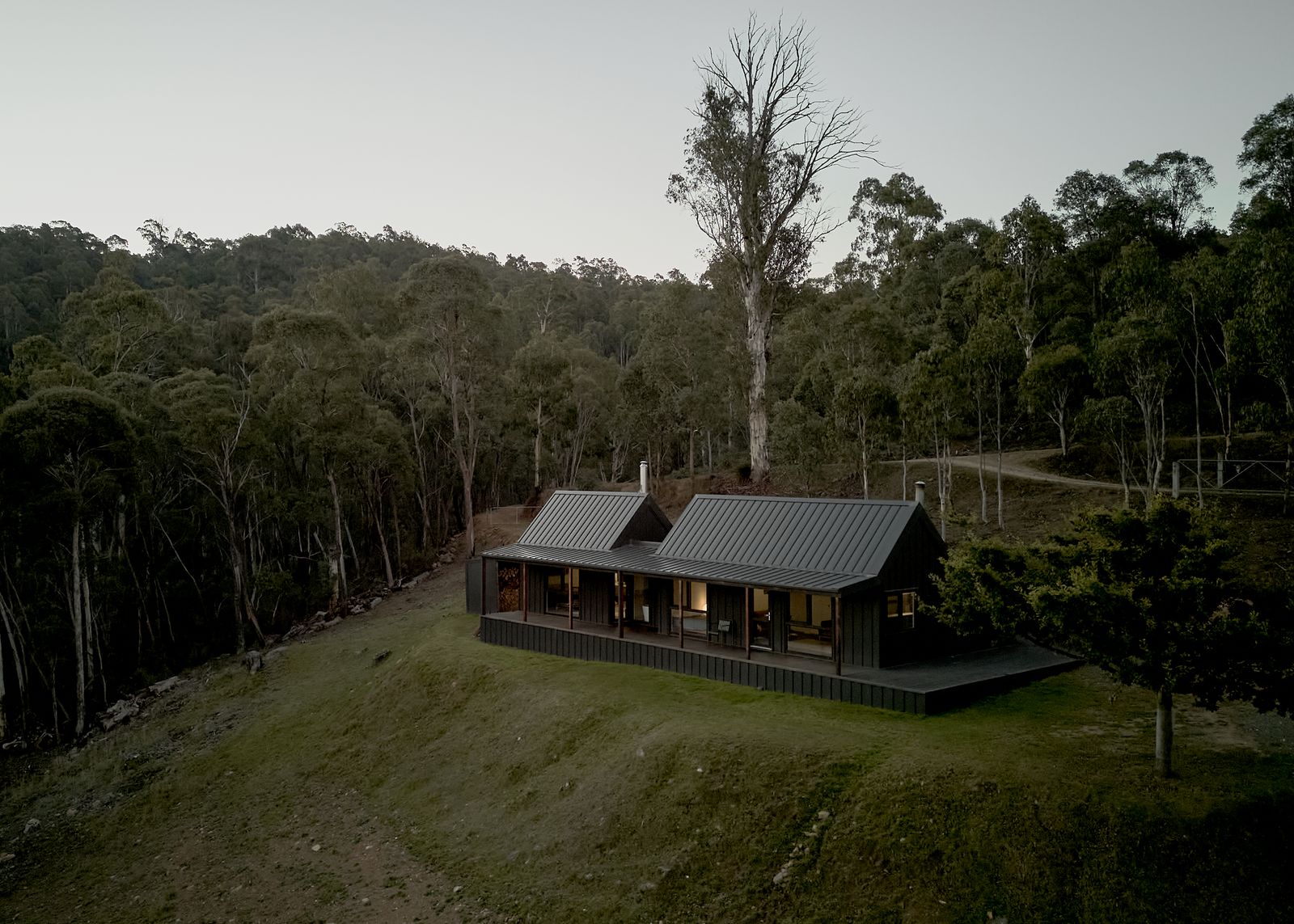 The cabin’s gabled form was reclad in black Colorbond steel. A new parents’ retreat extends off the deck to accommodate the growing family.