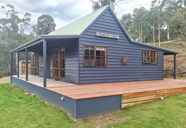 Before: The original pine cabin was a simple builder’s spec house: two bedrooms, one bathroom, and a wood stove that barely kept out the mountain chill.