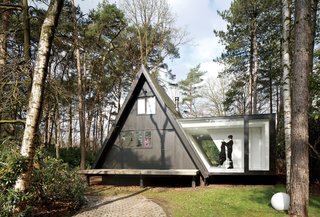 Adding 290 square feet to this already small (just 566 square feet) black A-frame in Brecht, Belgium, was all the local building ordinances allowed, but the architects at dmvA found that a single wing extended out to the side gave resident Rini van Beek all the storage and living space that she needs.