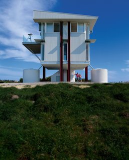 Gerard Kitchener and his partner Denise spend most weekends on top of an exposed hill in a two-level steel-and-glass tower on stilts.