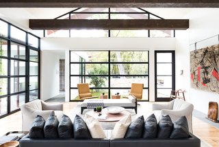 12 Striking Examples of Clerestory Windows in Modern Homes - Photo 6 of 12 - For this project, the husband loved ultra-modern design, while the wife leaned towards a more traditional aesthetic. How to please both? "Through the design process, we learned that their tastes were actually more closely aligned when we focused on the desired 'feel' of the home versus specific design details," Field says.<br><br>He and his colleagues balanced rustic, exposed ceiling beams with elegant Venetian plaster walls, and artful aluminum storefront windows with functional white oak plank flooring.