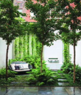 B&B Italia Outdoor’s Canasta sofa, by Patricia Urquiola, shares a shady patch in the ground-floor Carnegie Hill garden with three ginkgo biloba trees, an existing fountain with an Italian marble spout designed by Thomas Woltz, and bluestone pavers. The terrace is filled with woodland greenery: Leucothoe, ostrich ferns, and lady ferns.