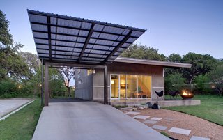 Wong consulted with an old neighbor, Austin-based landscape architect Eleanor McKinney, on landscaping, and she steered him toward a maintenance-free hardscape, which Wong designed himself with crushed granite, square pavers and limestone and basalt boulders from Austin Stone Supply. The lawn was already in place and never needs water, notes Wong. Just beyond the glass entrance door is the living/studio area; the interior stair leads to the sleeping loft.