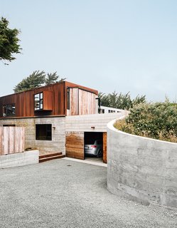 Cor-Ten steel and board-form concrete give the exterior a weathered look.