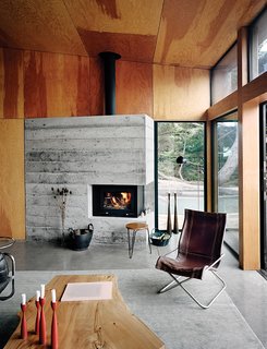 The living room is furnished with vintage items, including a leather-and-chrome chair by Suekichi Uchida and a stacking stool by Florence Knoll.