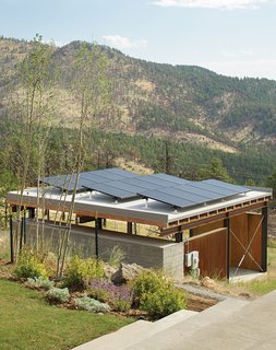 Sustainable Retreat on a Fire-Devastated Site in Boulder - Photo 2 of 7 - The Solar Revolution installed 3.6-kilowatt photovoltaic solar panels on top of the carport, which sports a board-formed concrete exterior and a cedar-slat-and-plywood interior.