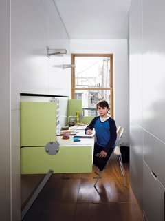 Storage-Smart Renovation in New York City - Photo 2 of 14 - Having a home office in an apartment of this size might seem impossible, but flexible furniture transforms one room into two.