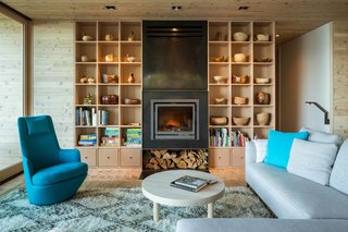 A sofa from Design Within Reach opposes a Hi Turn chair by Bensen in the living room.