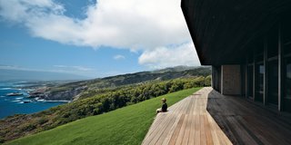 The clients cite Frank Lloyd Wright’s Mrs. Clinton Walker House in Carmel, California, as a very loose inspiration for the design of their house. From the deck off the kitchen and living area, Miha, nine years old, takes in an uninterrupted view of the Pacific Ocean.