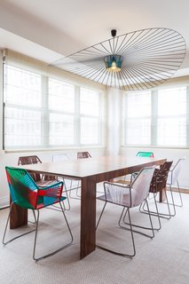 A statement pendant from Petite Friture was carefully selected to complement the weaving and patterns of the dining chairs by Patricia Urquiola for Moroso.