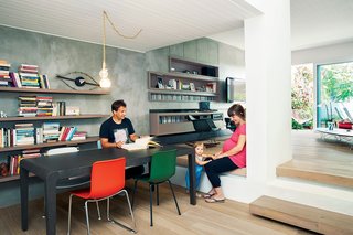 Odd Angles Don't Stop This Apartment's Transformation - Photo 3 of 8 - HAL Tube and Sledge chairs, by Jasper Morrison for Vitra, are arranged around an Extesso dining table by Neo Katoikein. A George Nelson Eye Clock sits on the cantilevered shelving by Pafos, a furniture company based in Oinofyta, Greece, which also constructed the built-in cabinets in the living room. The pendant lamp includes fixtures designed by Lee Broom for Oikos. 