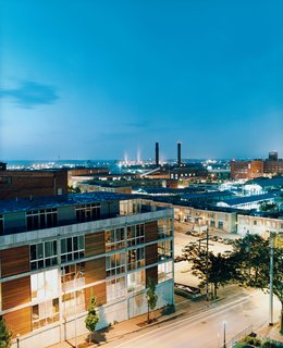 From across Delaware Street, the 5 Delaware lofts blend into their downtown surroundings. Just a block away, the stalls of the River Market, which gives the neighborhood its name, are visible in the background.