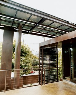 Solar Inspiration - Photo 4 of 8 - A steel-beam canopy with solar panels shades the house and provides electricity.