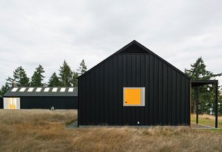 15 Modern Homes with Black Exteriors - Photo 14 of 15 - Architect Michelle Linden worked with Brothers to create a minimalist house. Inspired by the inward-looking approach of Cistercian abbeys, Linden oriented the U-shaped structure around a courtyard.