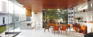 A Modern Concrete Home in Peru - Photo 3 of 13 - The dining area holds an adjunct kitchen designed for Lisette, a chef; the table base was repurposed from one from her former restaurant.