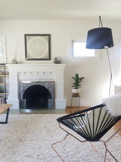 Alexandra Young's Craftsman-style bungalow in Oakland testifies to the wisdom of patiently accumulating a collection over many years. An ornate masonry fireplace fits easily into the home's historical mood, but like other rooms in the house, it has been updated with a modern fire screen.