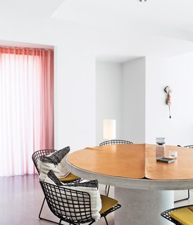 The only problem with Bertoia chairs is that once you have one you're going to want more. Here Bertoia steel side chairs for Knoll ring the concrete dining table that the owners of this Belgian home designed themselves. Photo by Frederik Vercruysse.