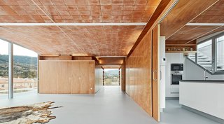 In the Catalonia region of Spain, architecture firm Fake Industries Architectural Agonism in concert with Aixopluc created a house that combines industrially manufactured components with a handmade, Catalonian vaulted-brick roof.
