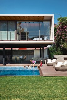 10 Retreats in Mexico For the Modernists Who Love the Outdoors - Photo 1 of 10 - On an idyllic afternoon, members of the Oropeza and Castillo clans splash in the backyard pool framed by Trex decking and outfitted with furniture by Móbica.