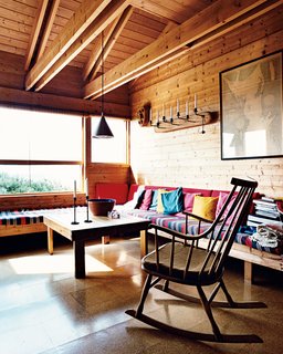 Built-in benches function both as seating and as spare beds in the living room. Holm says the striped, hand-woven fabric she found in Greece is indestructible, and the cork flooring throughout the house has gone 40 years without needing replacing.