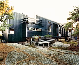 Blocked from the wind, a deck at the rear of the house is a favorite place for sunbathing and also shelters planters of herbs.