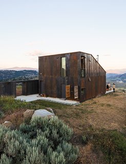 14 Totally Off-the-Grid Cabins - Photo 14 of 14 - A narrow building next to the main structure houses storage and an outdoor kitchen.