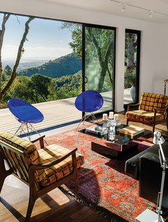 This Northern California Prefab Gets a Dose of Universal Design - Photo 3 of 8 - In the living room, interior designer Meredith Rebolledo of Ma(i)sonry Napa Valley paired pieces like Philippe Starck’s Eros chairs for Kartell and two 1960s Swedish chairs with the client’s Oushak rug.