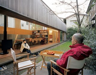 The entire interior wall opens, extending the house visually and socially into the small garden that lies between the multigenerational family’s two homes. The boys’ favorite feature is the soccer goalpost (which doubles as clothesline).