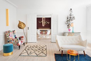 Design Dictionary: Tulip Chair - Photo 9 of 10 - In an apartment turned showroom in Copenhagen, dark red walls set off the dining room’s Pedestal Collection.