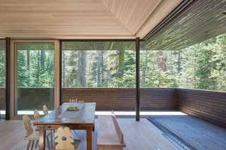 Imported Tyrolean dining chairs and a custom bench designed by Lexie pair well with the family’s antique leaf table under the Douglas Fir ceiling.