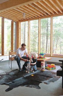 McMinn, an architect, helps Soren construct a TinkerToy tower. The cowhide rug is from Perfect Leather Goods, and the Wassily Chair is by Marcel Breuer for Knoll.