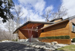 The Douglas fir slats cover the facade and are repeated throughout the rest of the house. Moser references the woods by a pair of steel beams on the front porch that allude to the silhouette of a tree.