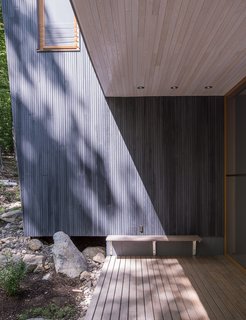 Custom-milled vertical groove tamarack clads the exterior.