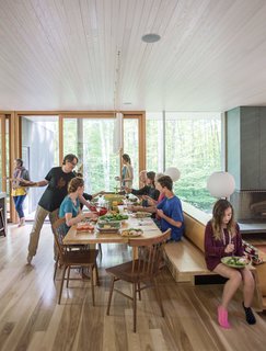 The house is about 3,000 square feet with six bedrooms, four of them on the second floor, surrounding a stairway to the large open space below where cooking, dining, game-playing, and movie-watching take place.