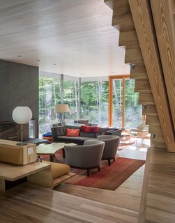 One-inch-thick slate clads the fireplace in the living room, which opens to a terrace. The reclaimed coffee table is by Scott Chambers.