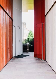 Color is one way the architects differentiated the structures, as in the custom doors they designed for the entrances in contrasting light and dark light finishes.