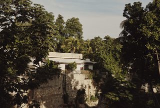 A view of Azor’s home across a gully where a shallow creek runs; its gently babbling water is audible from his backyard.