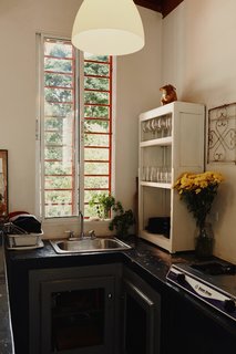The kitchen is lit by an IKEA pendant light.