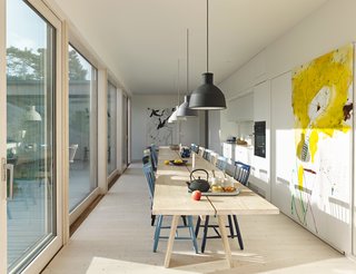 A custom table designed by Staffan Holm, capable of seating 26, runs the length of Anders Bergström and Kristina Lagercrantz’s kitchen in Gothenburg. Unfold pendants by Form Us With Love for Muuto, Lilla Åland chairs by Carl Malmsten for Stolab, and a painting by Hampus Pettersson complete the space.