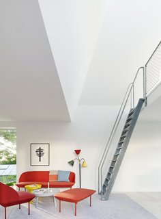 In a small seating area at the base of a two-story tower, Oslo chairs and sofas by Anderssen& Voll are paired with Around tables by Thomas Bentzen, all from Muuto. The lamp from Svenskt Tenn was designed by Josef Frank in 1938.